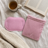 HydroHeat period wrap laid flat on a bed with tea and a book