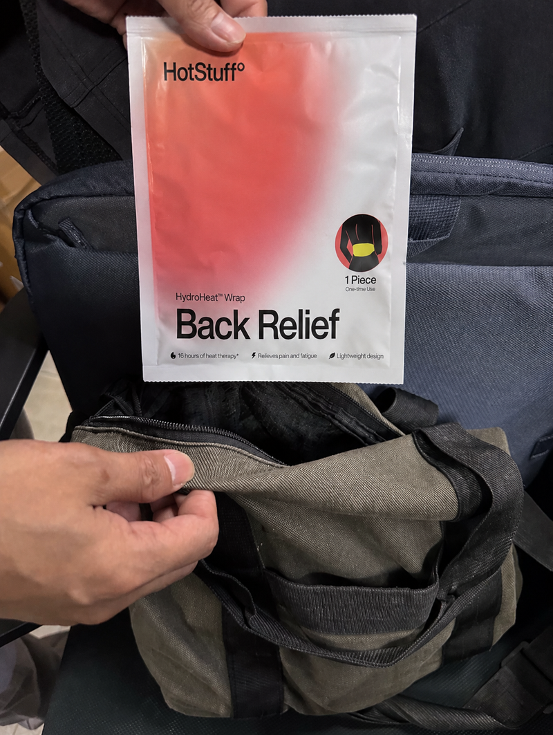 A single HotStuff Back Relief sachet held beside a gym bag