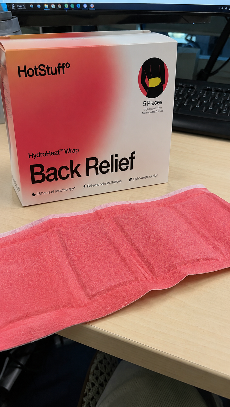 HotStuff Back Relief box beside the unwrapped coral heat wrap on an office desk