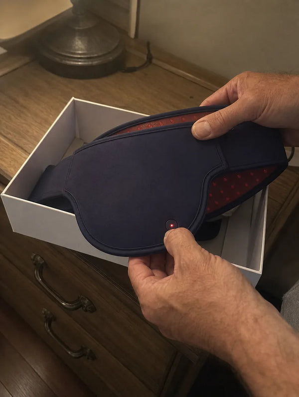 Hands lifting the device from its box and pressing the power button