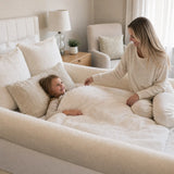 Mother and child cozy together in The Cocoon bordered nest bed